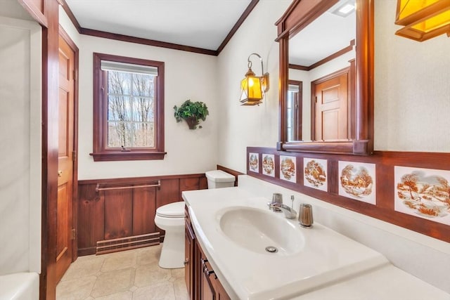 bathroom featuring visible vents, wainscoting, toilet, crown molding, and vanity