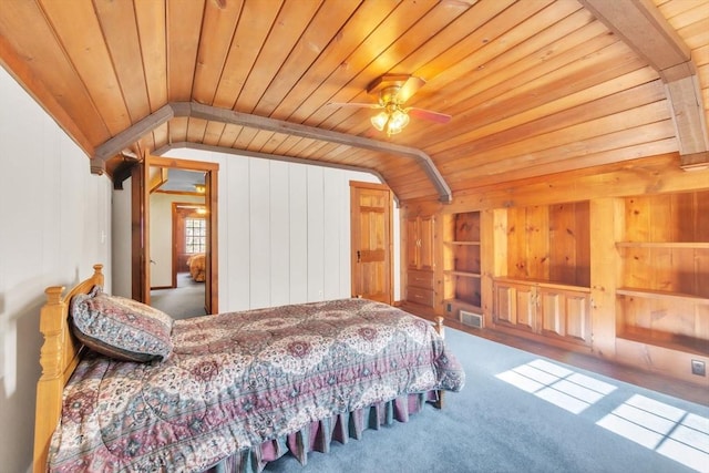 carpeted bedroom with wooden ceiling, visible vents, vaulted ceiling, and wooden walls