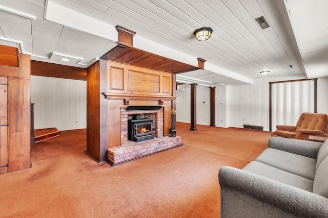 living room featuring wooden ceiling, carpet flooring, visible vents, and wooden walls