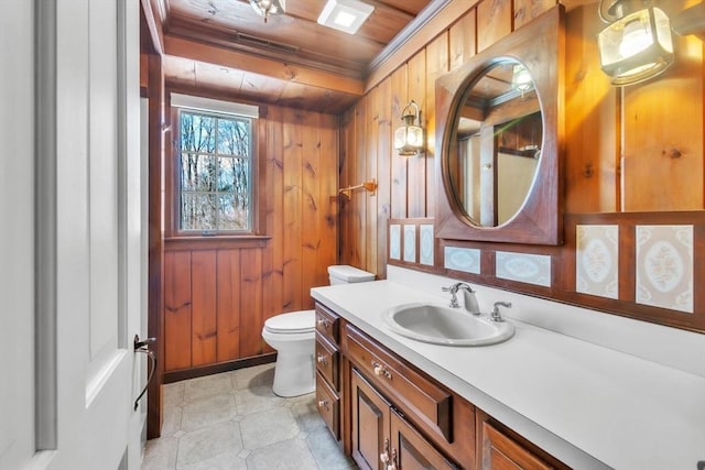 bathroom with crown molding, toilet, wood ceiling, wooden walls, and vanity