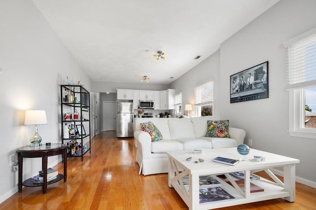 162 Willow Rd Unit 11, Nahant, MA 01908 - living room featuring light wood-style floors and a chandelier