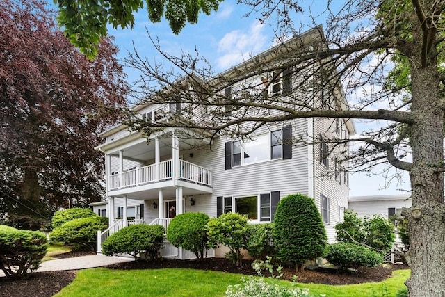 162 Willow Rd Unit 11, Nahant, MA 01908 - view of front of house with a balcony, a front lawn, and covered porch