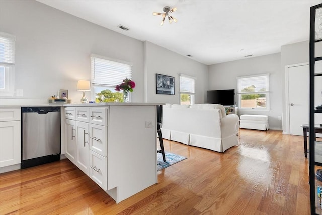 162 Willow Rd Unit 11, Nahant, MA 01908 - kitchen with dishwasher, white cabinetry, light wood finished floors, and a peninsula
