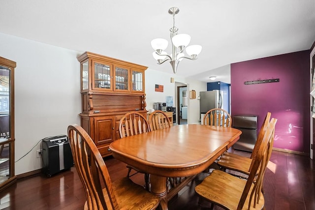 dining room featuring baseboards, an inviting chandelier, and dark wood finished floors