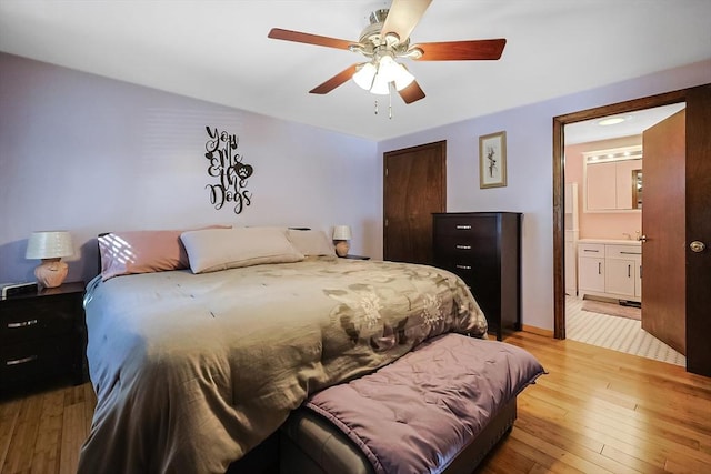 bedroom featuring light wood-style floors, a closet, ensuite bathroom, and ceiling fan