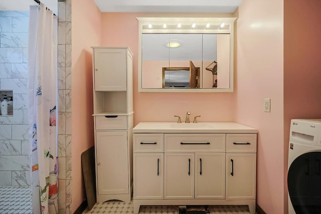 full bath featuring vanity, washer / clothes dryer, and tiled shower