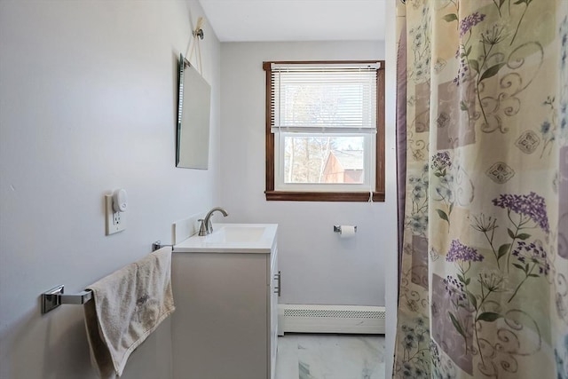 bathroom featuring a baseboard heating unit, curtained shower, and vanity