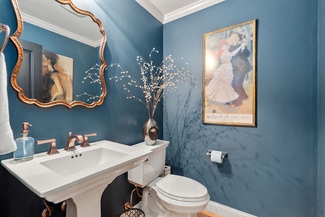 bathroom with ornamental molding, sink, and toilet