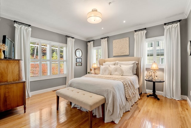 bedroom featuring crown molding and light wood-type flooring