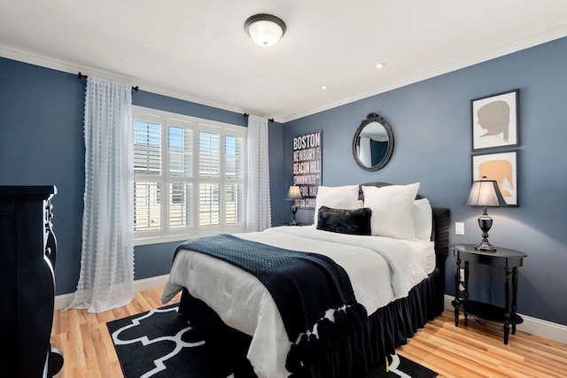 bedroom with hardwood / wood-style flooring and ornamental molding