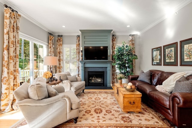 living room with crown molding, light hardwood / wood-style flooring, and a fireplace