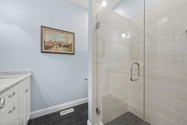 bathroom with a shower with door and vanity