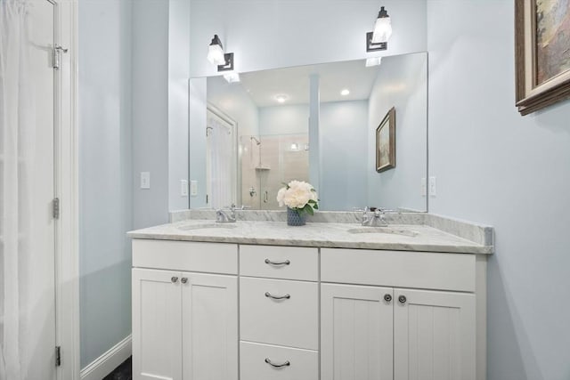 bathroom featuring a shower with door and vanity