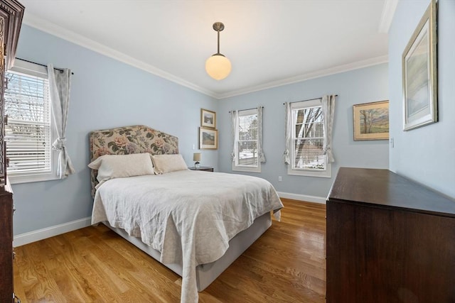 bedroom featuring light wood-type flooring and crown molding