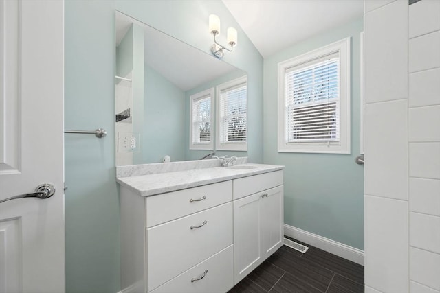 bathroom featuring vanity and vaulted ceiling