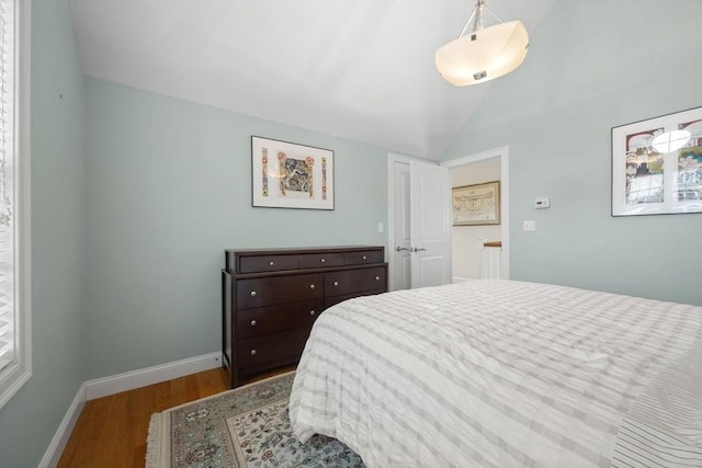 bedroom featuring lofted ceiling and wood-type flooring