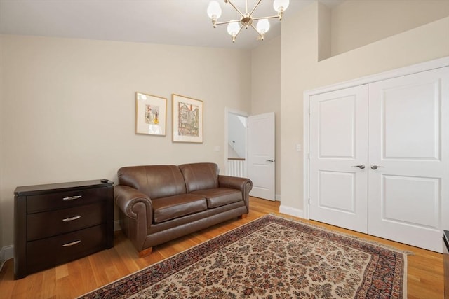 interior space featuring light hardwood / wood-style flooring, an inviting chandelier, and high vaulted ceiling