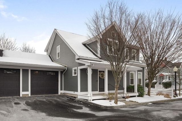 view of front of home featuring covered porch and a garage