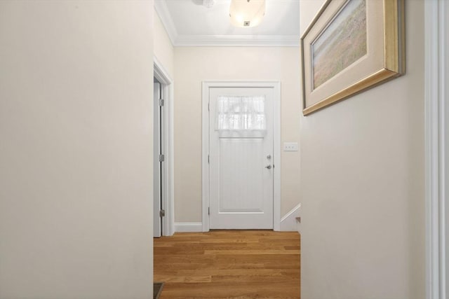 doorway to outside featuring crown molding and light hardwood / wood-style flooring