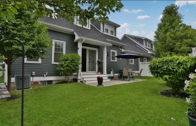 back of property featuring central AC, a patio area, and a lawn