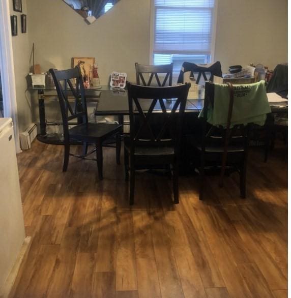 dining room with hardwood / wood-style flooring and a baseboard radiator