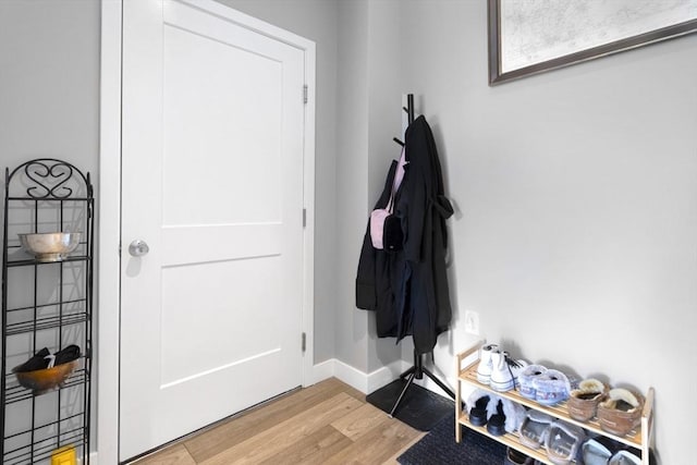entryway with wood finished floors and baseboards