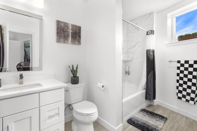 full bath featuring wood finished floors, toilet, vanity, baseboards, and shower / bath combo