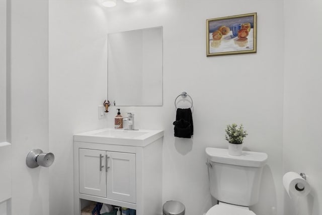 bathroom featuring toilet and vanity
