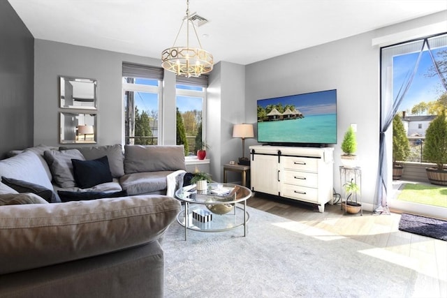 living area featuring wood finished floors and a chandelier