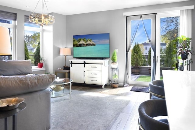 living room with wood finished floors and a chandelier