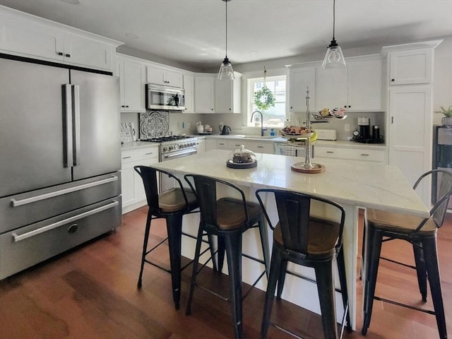 391 Gibbs St, Fall River, MA 02720 - kitchen featuring premium appliances, white cabinets, and a kitchen breakfast bar