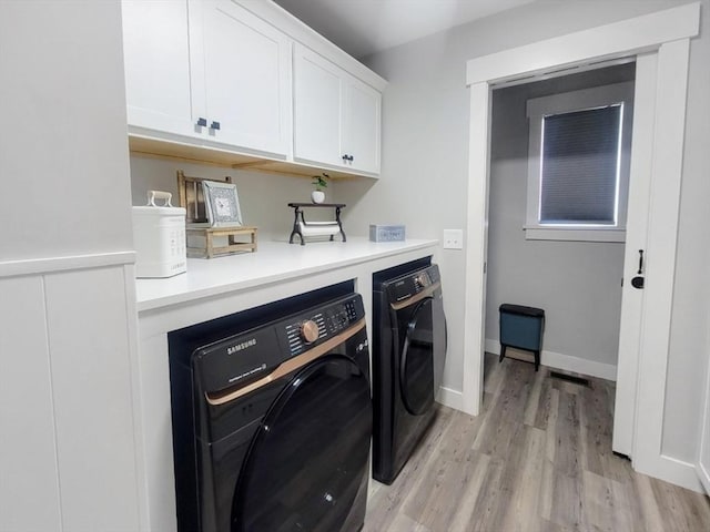 391 Gibbs St, Fall River, MA 02720 - laundry area with cabinet space, washer and dryer, and light wood finished floors