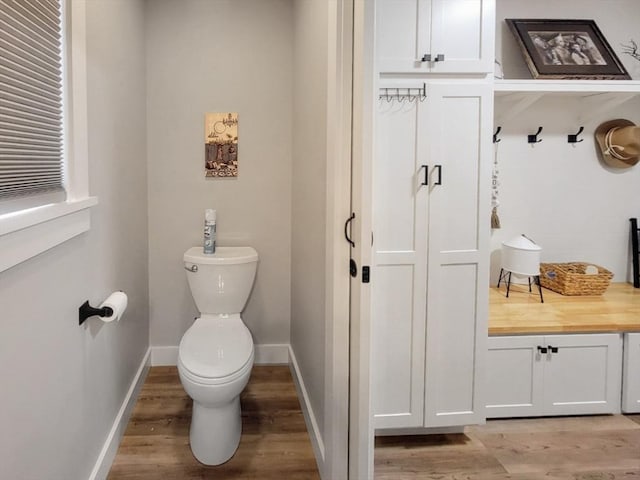 391 Gibbs St, Fall River, MA 02720 - bathroom with toilet, wood finished floors, and baseboards