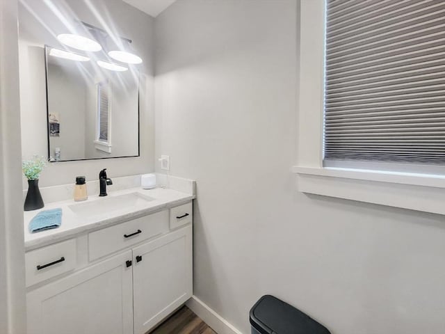 391 Gibbs St, Fall River, MA 02720 - half bath with vanity, baseboards, wood finished floors, and toilet