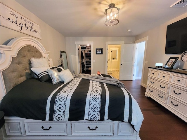 391 Gibbs St, Fall River, MA 02720 - bedroom with a walk in closet, dark wood-style flooring, baseboards, a closet, and ensuite bath