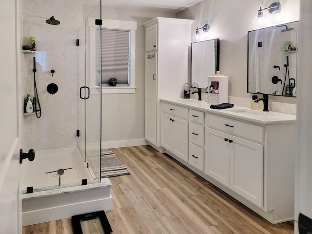 391 Gibbs St, Fall River, MA 02720 - full bath with a shower stall, double vanity, and wood finished floors