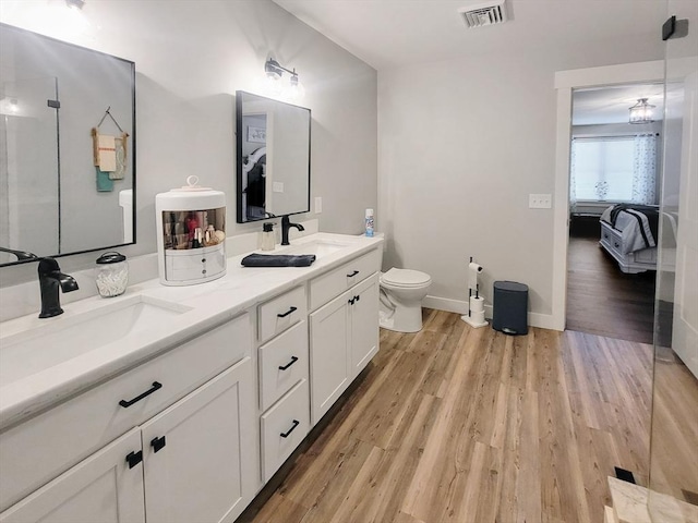 391 Gibbs St, Fall River, MA 02720 - ensuite bathroom featuring toilet, wood finished floors, double vanity, and baseboards