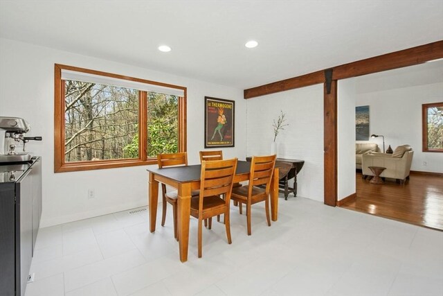 dining space with plenty of natural light, recessed lighting, and baseboards