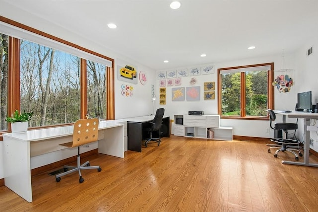 home office featuring built in desk, light wood finished floors, recessed lighting, and baseboards