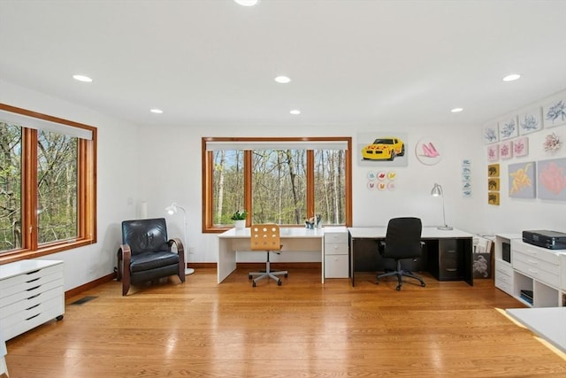 home office with light wood finished floors, recessed lighting, baseboards, and a healthy amount of sunlight