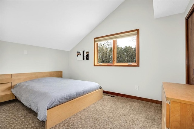 carpeted bedroom with visible vents, lofted ceiling, and baseboards
