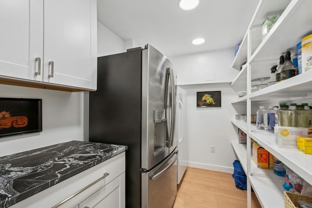 kitchen featuring open shelves, stainless steel refrigerator with ice dispenser, white cabinetry, and light wood-style floors