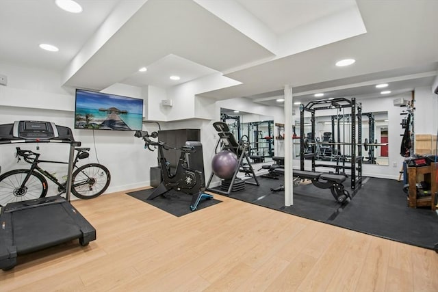 gym featuring recessed lighting, wood finished floors, and baseboards