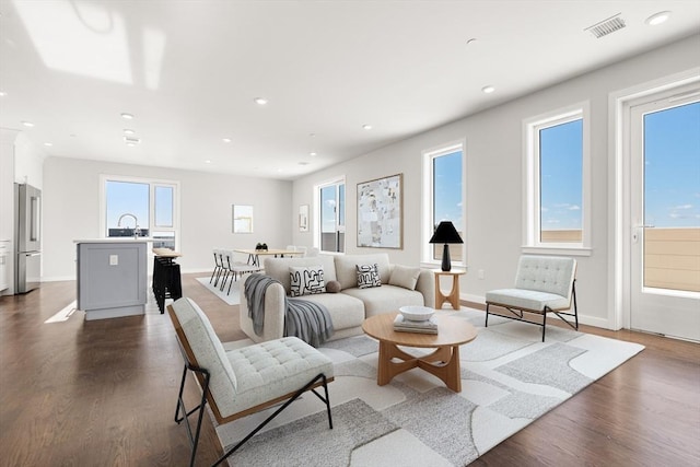 living area featuring plenty of natural light, recessed lighting, and wood finished floors