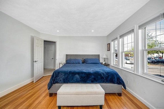 bedroom featuring light wood finished floors, baseboards, and recessed lighting