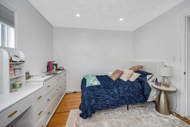 bedroom with light wood-style floors and recessed lighting