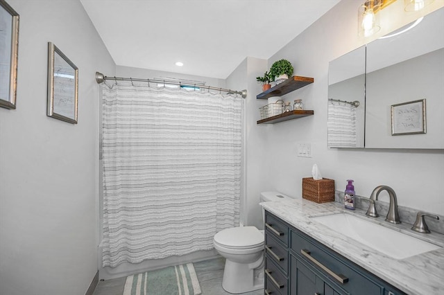 bathroom featuring toilet, vanity, and a shower with shower curtain