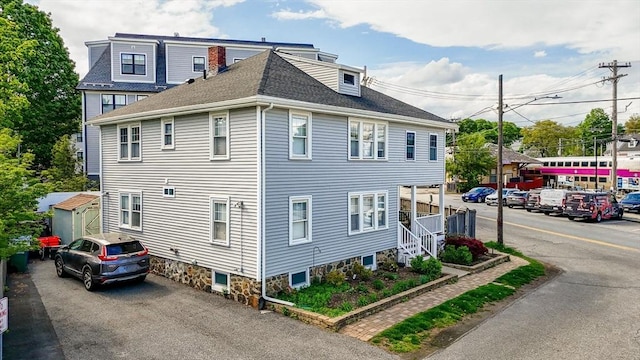 view of home's exterior with roof with shingles