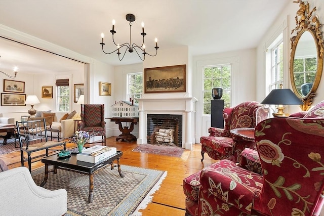 9 The Cmn, Royalston, MA 01368 - living room featuring plenty of natural light, a chandelier, light wood-type flooring, and a fireplace with flush hearth