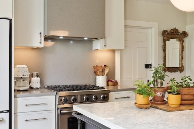 9 The Cmn, Royalston, MA 01368 - kitchen with high end stainless steel range, light countertops, exhaust hood, white cabinets, and fridge